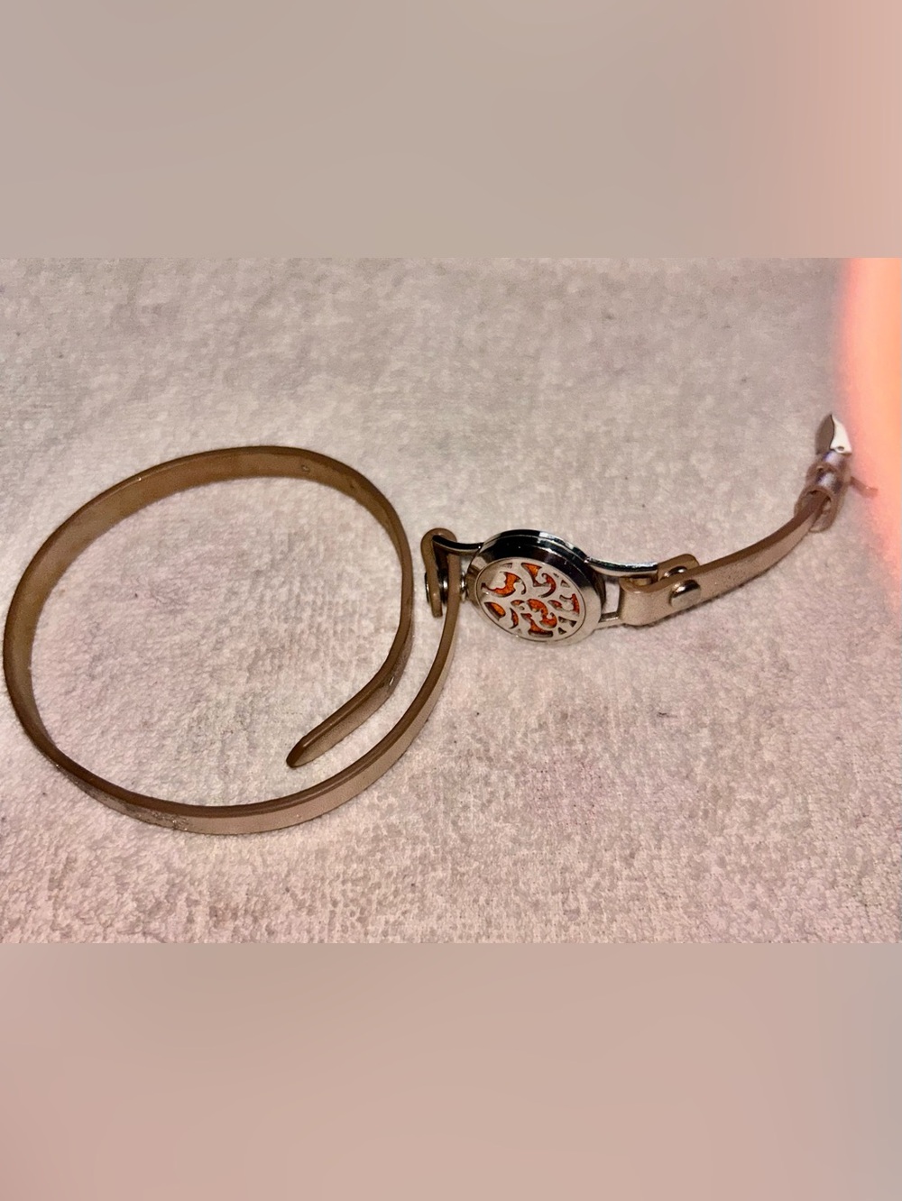Silver Round Floral Cutout Pendant oil infused on leather bracelet.